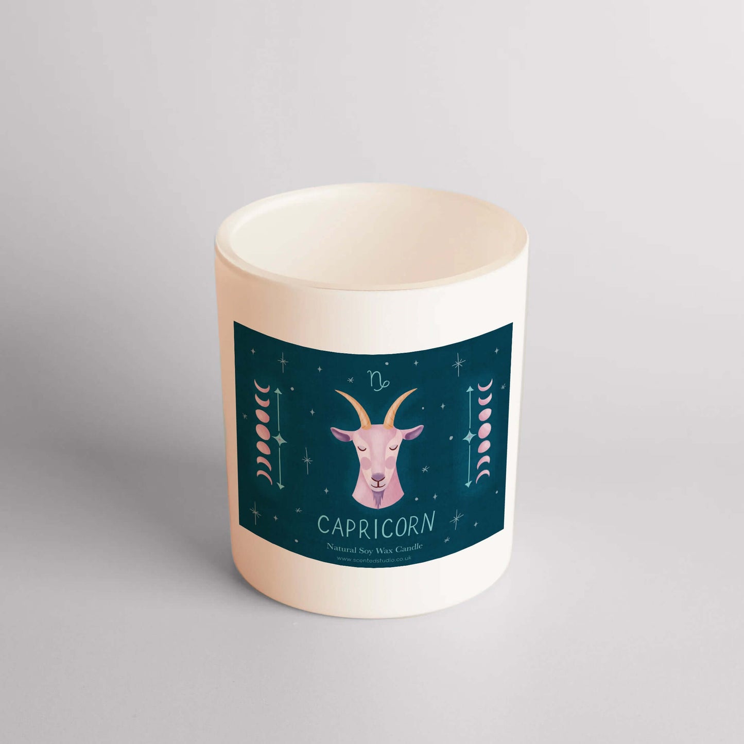 Capricorn star sign candle in matte white vessel with French vanilla scent, featuring zodiac design and customize toppings option.